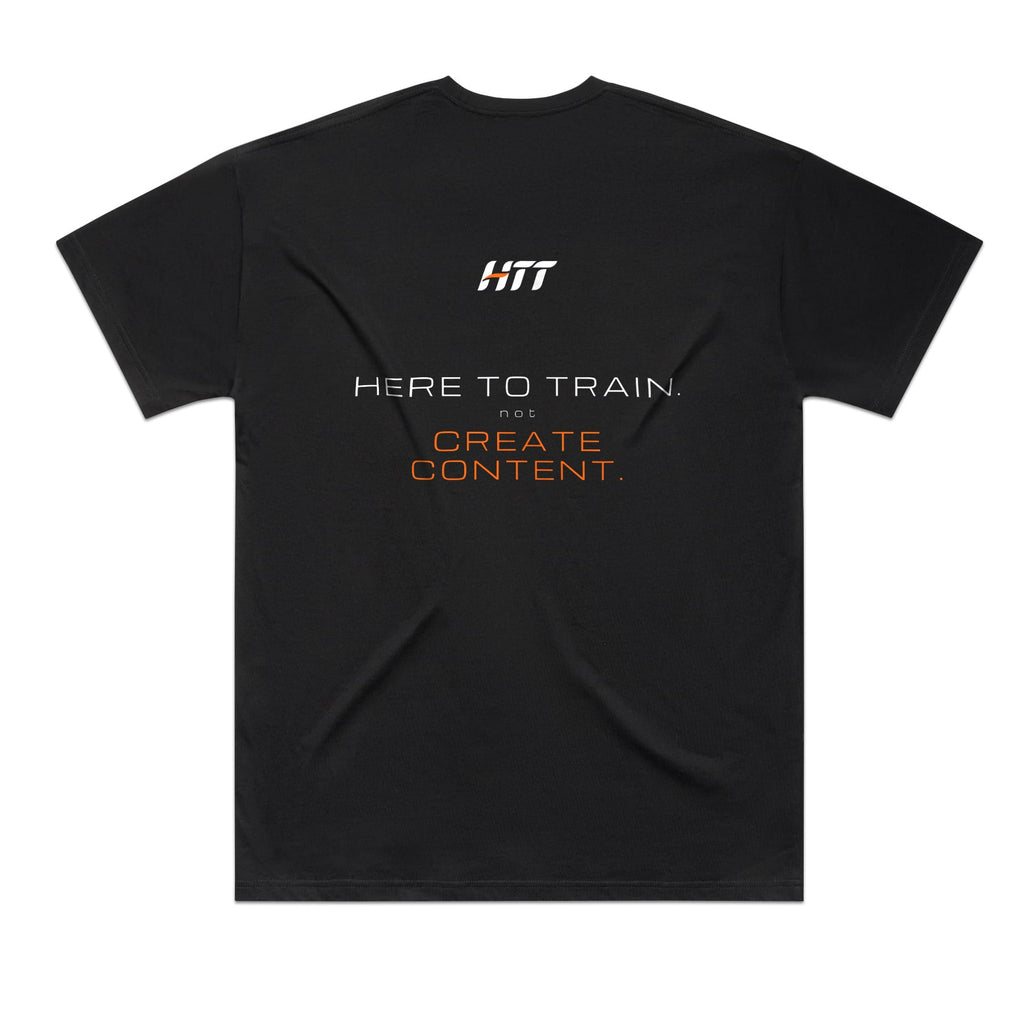 Back of a black HTT oversized tee printed HERE TO TRAIN. NOT CREATE CONTENT.