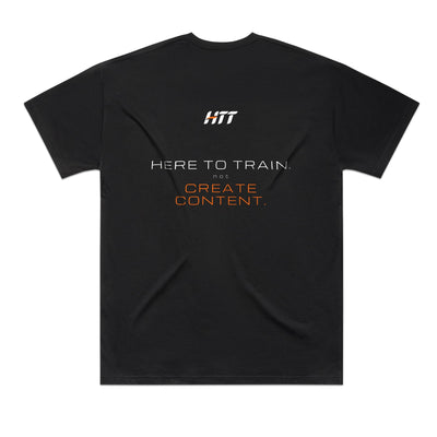 Back of a black HTT oversized tee printed HERE TO TRAIN. NOT CREATE CONTENT.