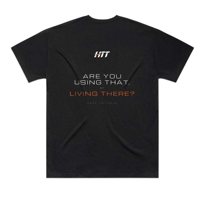 Back of a black HTT oversized tee printed ARE YOU USING THAT, OR LIVING THERE?