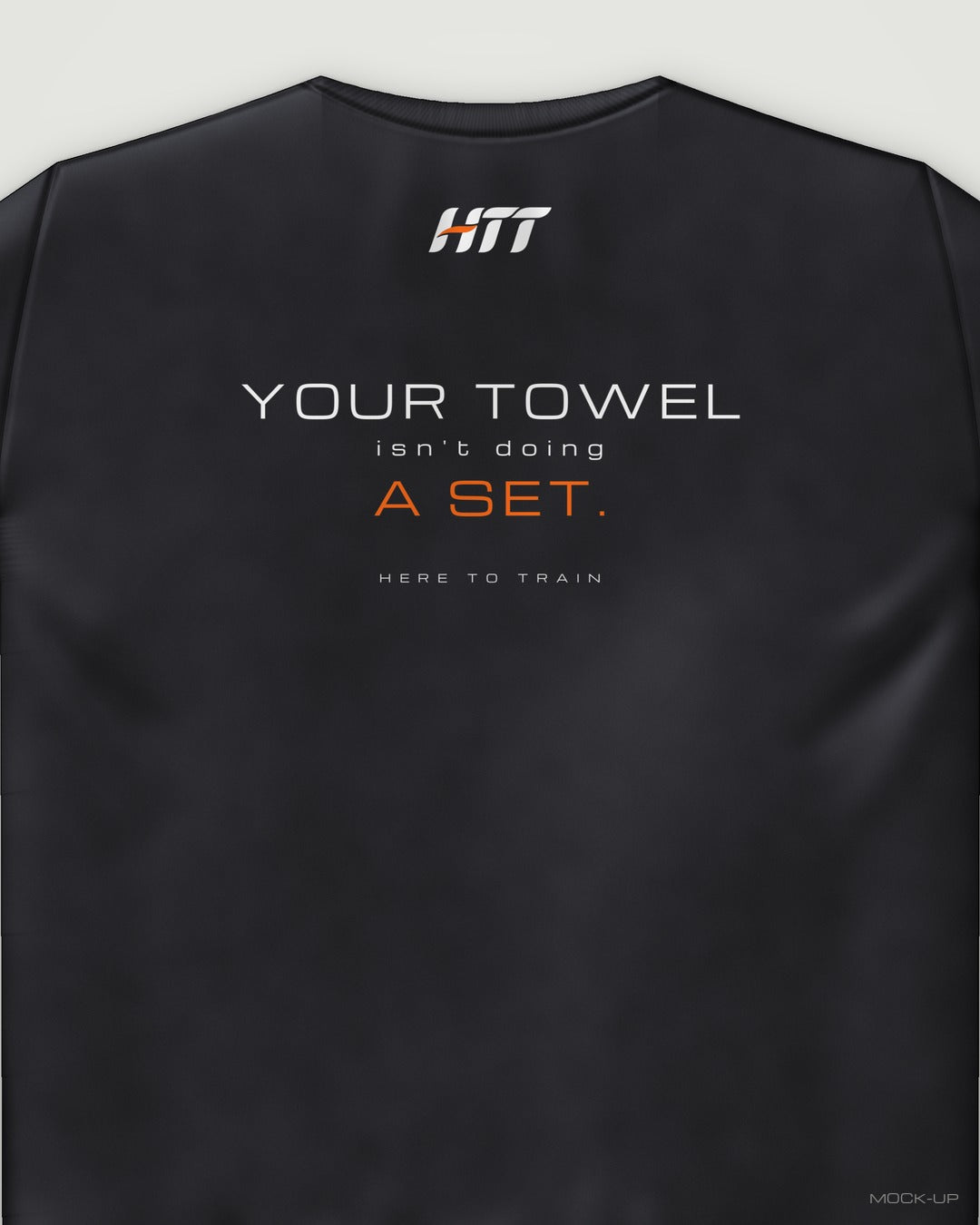 Back of a black HTT standard fit tee printed YOUR TOWEL ISN'T DOING A SET. (portrait crop)