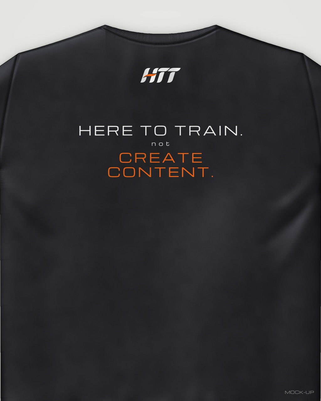 Back of a black HTT standard fit tee printed HERE TO TRAIN. NOT CREATE CONTENT. (portrait crop)