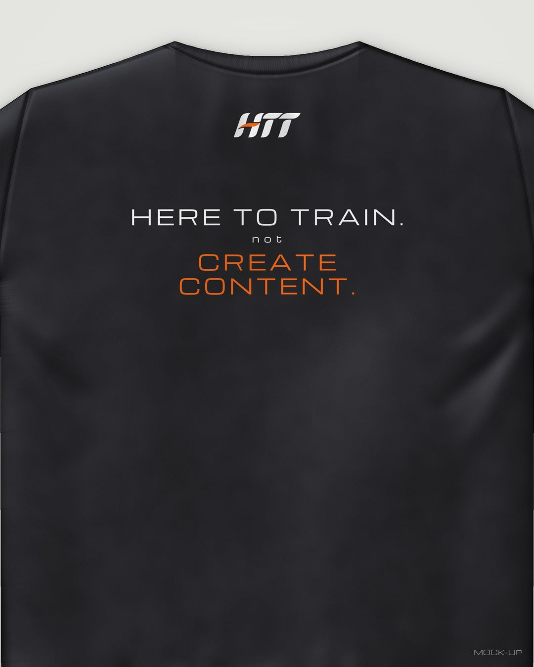 Back of a black HTT standard fit tee printed HERE TO TRAIN. NOT CREATE CONTENT. (portrait crop)