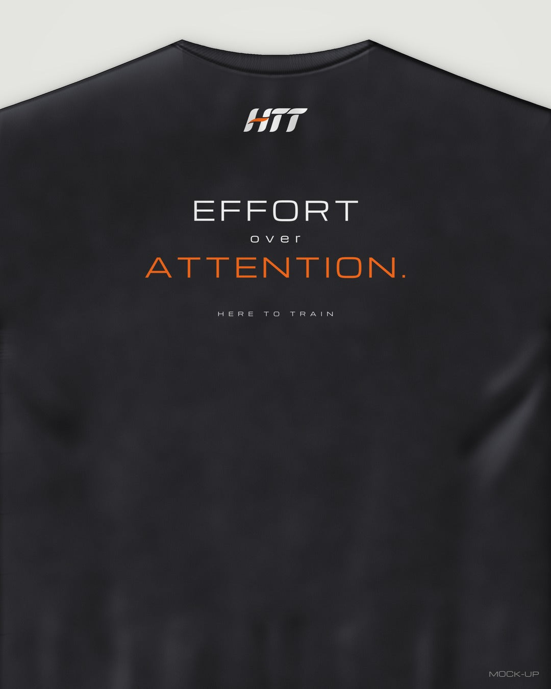 Back of a black HTT oversized tee printed EFFORT OVER ATTENTION. (portrait crop)