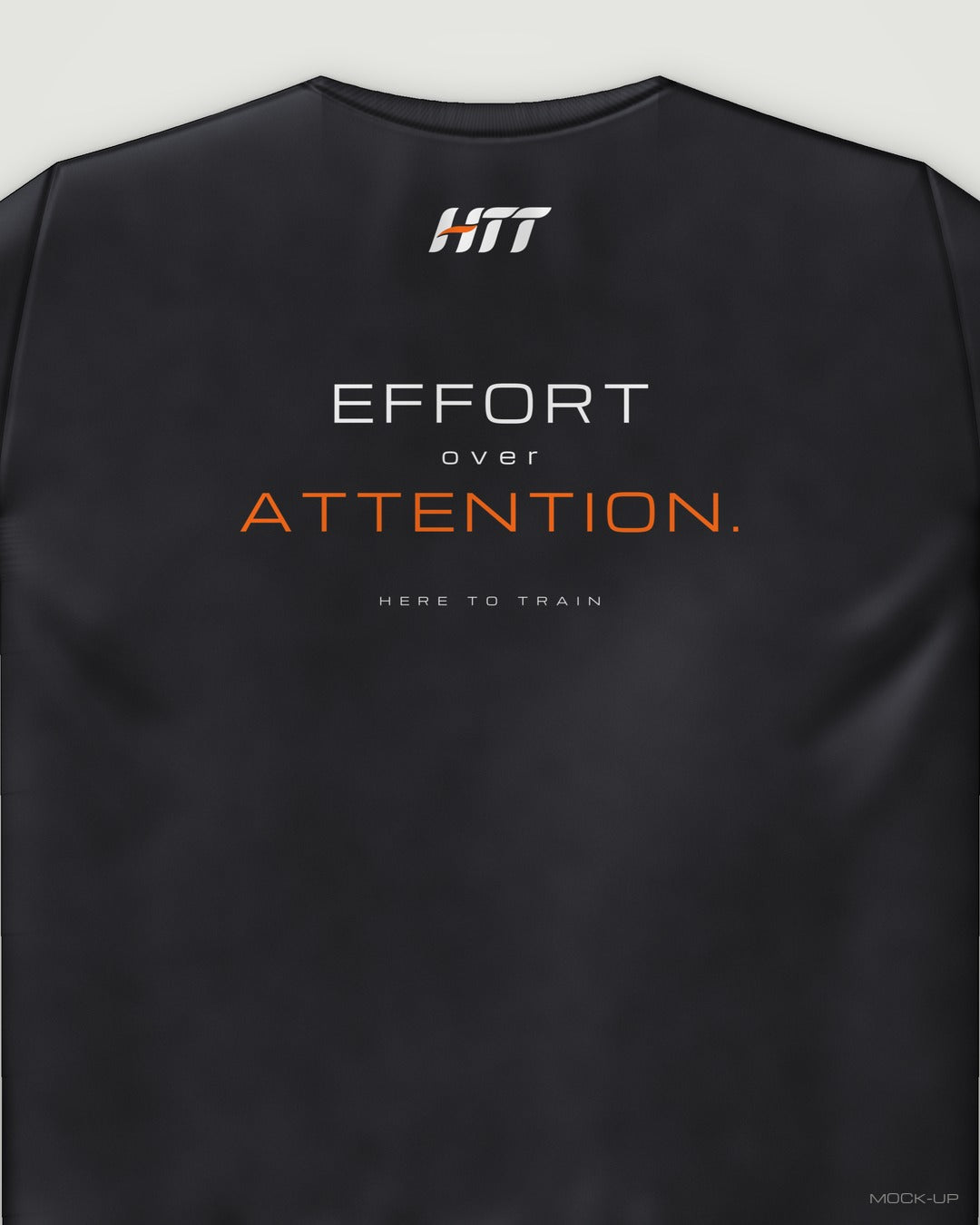 Back of a black HTT standard fit tee printed EFFORT OVER ATTENTION. (portrait crop)