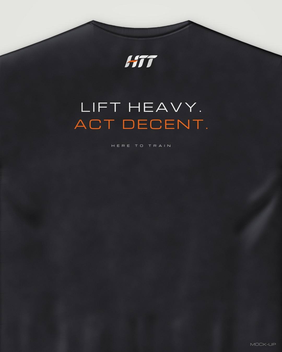 Back of a black HTT oversized tee printed LIFT HEAVY. ACT DECENT. (portrait crop)